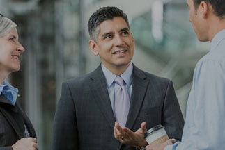 female and two male businesspeople talking