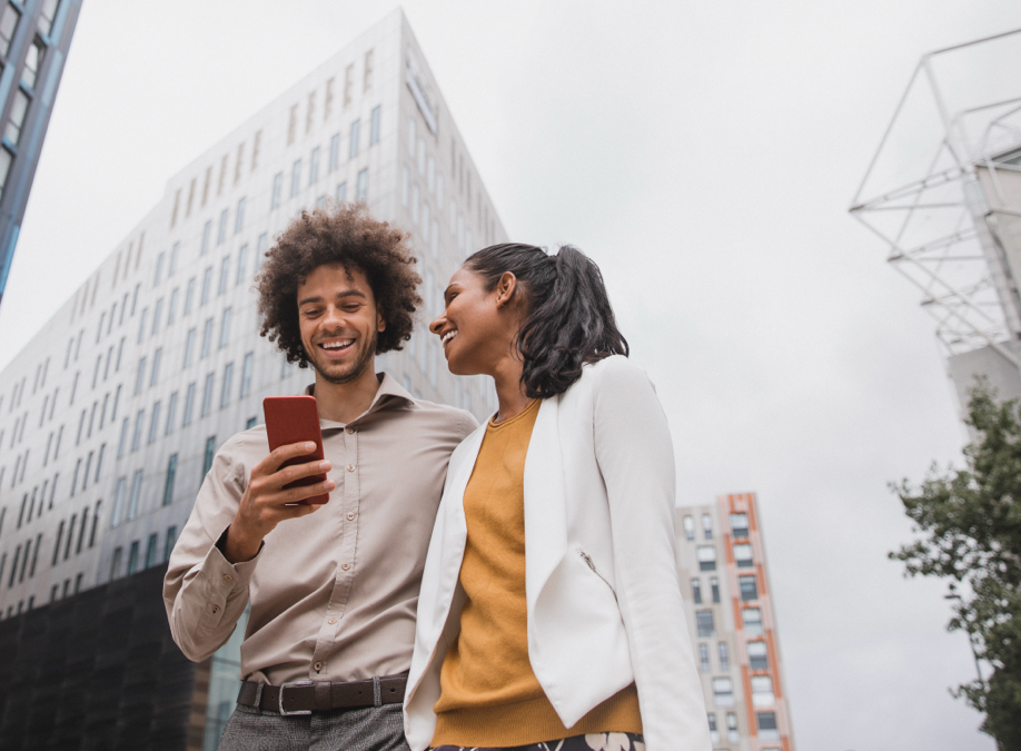 woman looking at man while man looking in mobile 